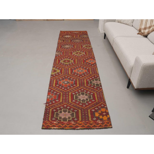 Vintage Hand-Knotted runner rug is a semi-antique vintage area rug. The '70s Eastern region of Anatolia's unique rug is...