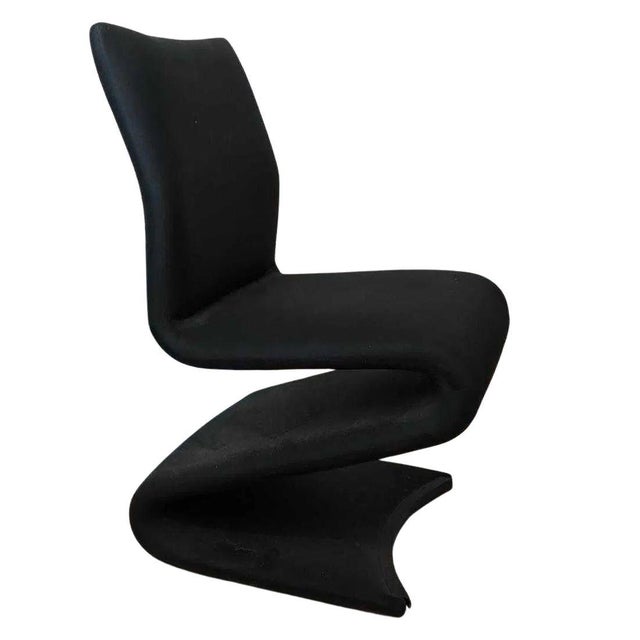A set of eight Mid-Century Modern Z-shape cantilever side chairs featuring a sculptural one piece silhouette with graceful...