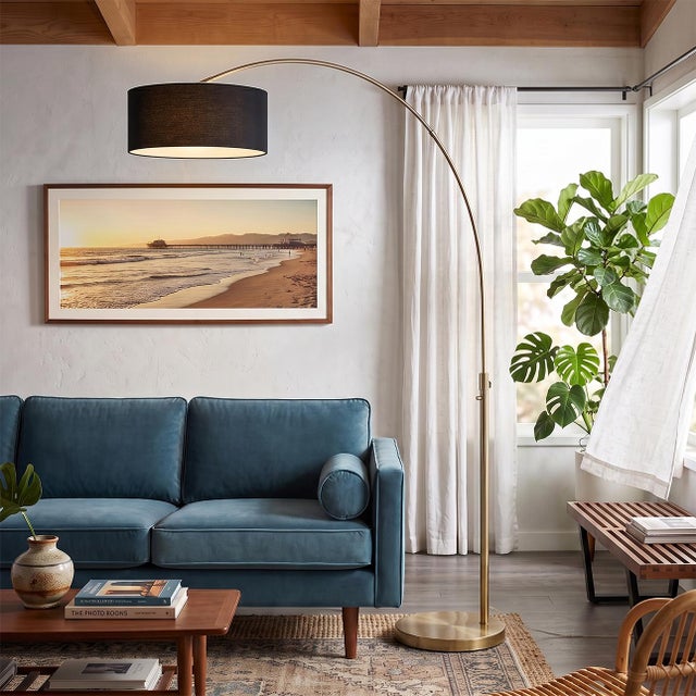 Weathered brass paired with a steel base defines the Float Arc Lamp, a modern design by Peter Morelli. This elegant arc...