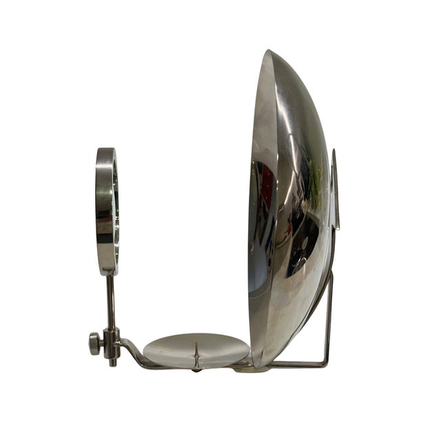 A fascinating vintage medical examination instrument featuring a large concave reflector mirror, adjustable magnifying...