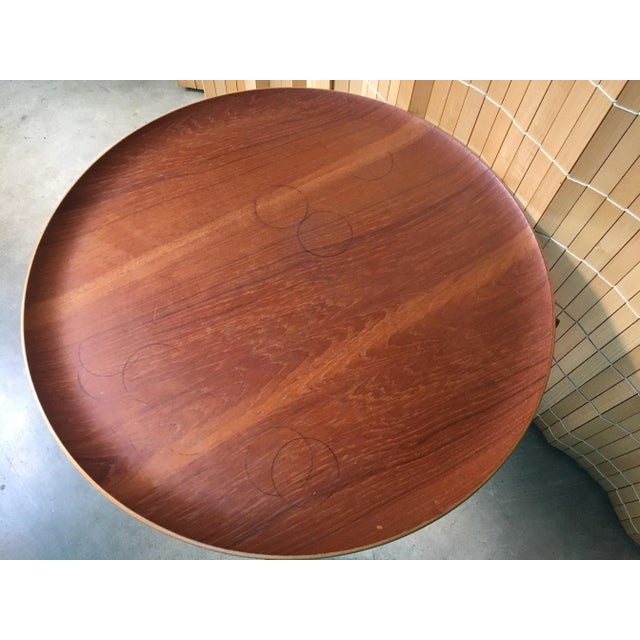 Mid century modern Fritz Hansen folding accent tray table Model 0266. Features teak tapered legs with a light round tray...