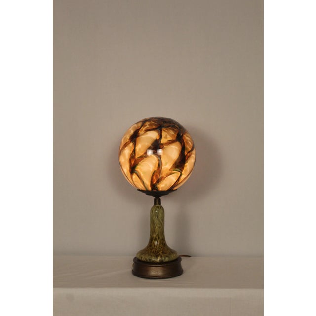 Unusual hand blown Murano sphere mounted on a complementary hand blown base, In the style of Art Nouveau When illuminated...