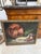 This is an oil still life in the classic kitchen-table tradition. A large copper cauldron lies tipped on its side at the...