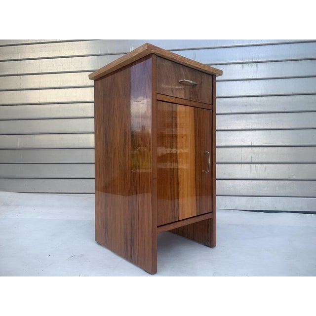 FREE-STANDING CABINET with drawer, 1970s Made of furniture board, covered with natural walnut veneer and finished with a...