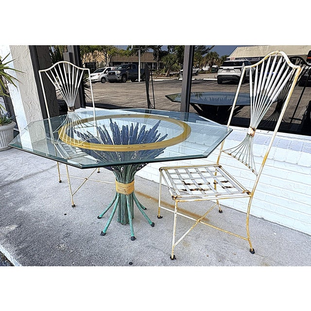 Pretty Italian Hollywood Regency style outdoor dining set from the 1960's. The set is made of heavy metal and includes two...