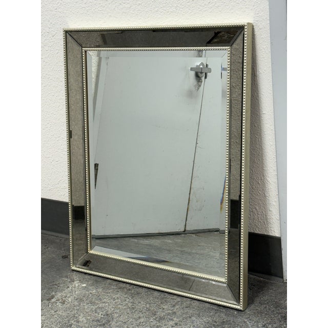 Design Plus Gallery presents a Silver Beaded Frame Wall Mirror. This rectangular mirror displays a wide border of antiqued...