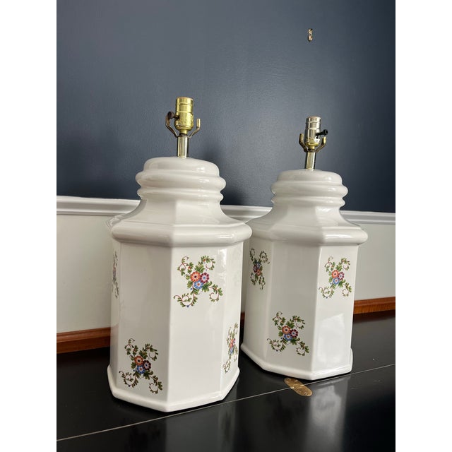 An elegant pair of antique European style porcelain table lamps, embodying the refined ease of English country and château...