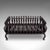 This is an antique fire basket. An English, cast iron fireplace grate dating to the Edwardian period, circa 1905. A...