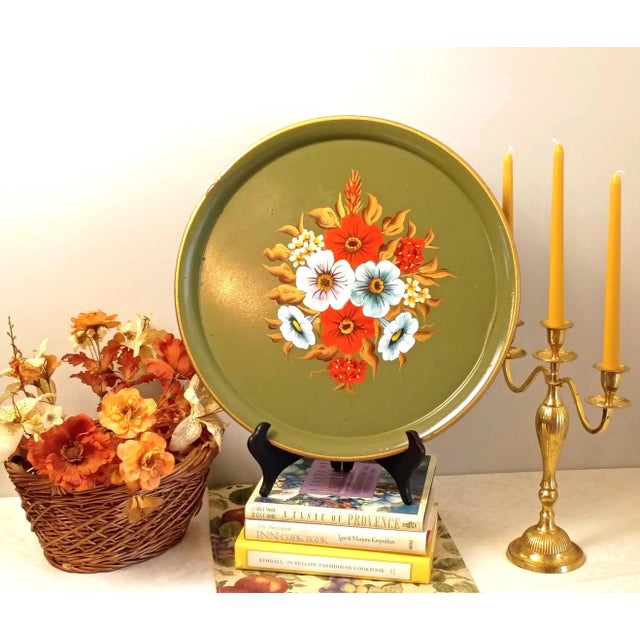 This vintage toleware metal tray features a vibrant hand-painted floral bouquet centering a muted olive green enameled...