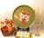 This vintage toleware metal tray features a vibrant hand-painted floral bouquet centering a muted olive green enameled...