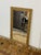 Design Plus Gallery presents a Gilt Wood Wall Mirror in Gold. The beveled edge mirror is inset in a heavy carved frame...