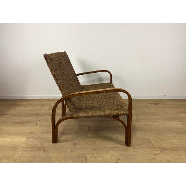 Two-seater sofa with a wooden frame and woven rope upholstery, designed by Augusto Romano in the 1940s. The sofa has been...