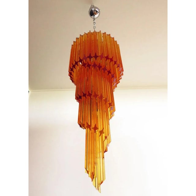 This chandelier is made of 86 Murano crystal amber prism in a nickel metal frame.The shape of this chandelier is spiral....