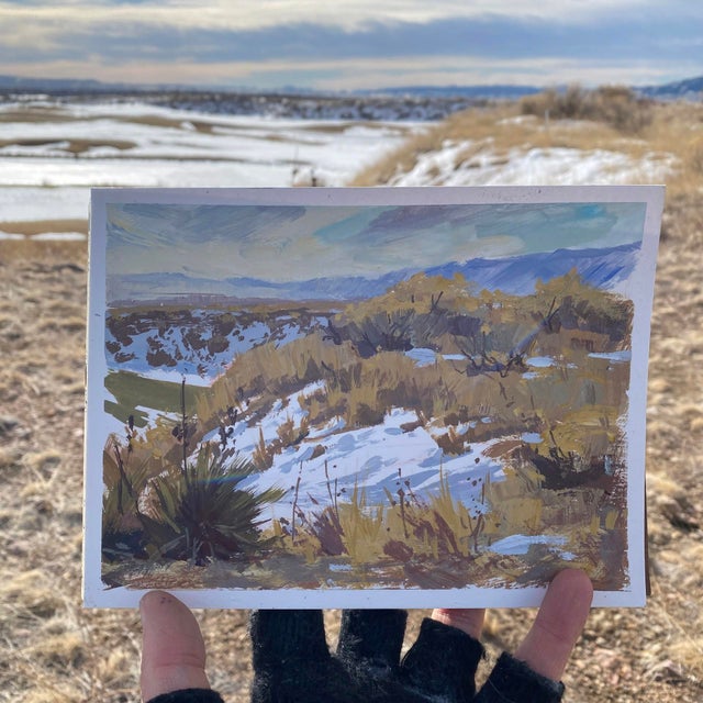 This gouache painting captures a serene landscape in Morrison, Colorado, where gentle hills meet distant mountains under a...