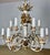 Italian twelve light painted & parcel gilt Rococo style chandelier with carved wood cherubs. The fixture is made of iron &...