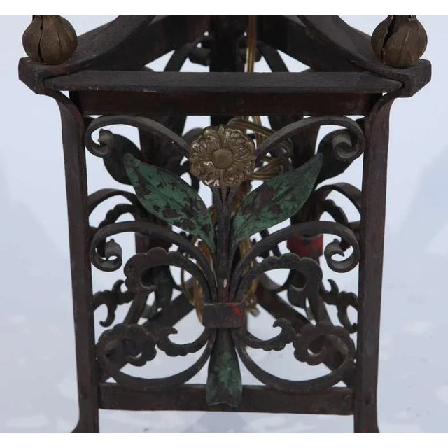 Pair of 1900 - 1920s Italian wrought iron and polychromed torchieres. They have been newly wired. The base measurement is...