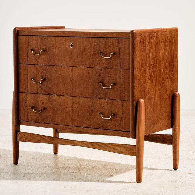 Danish teak and oak dresser in restored condition with three drawers and special shaped brass handles from the 1960s.