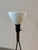 Exceptional mid-century modern tripod floor lamp. Features three slender black metal legs, brass toned central stem and...