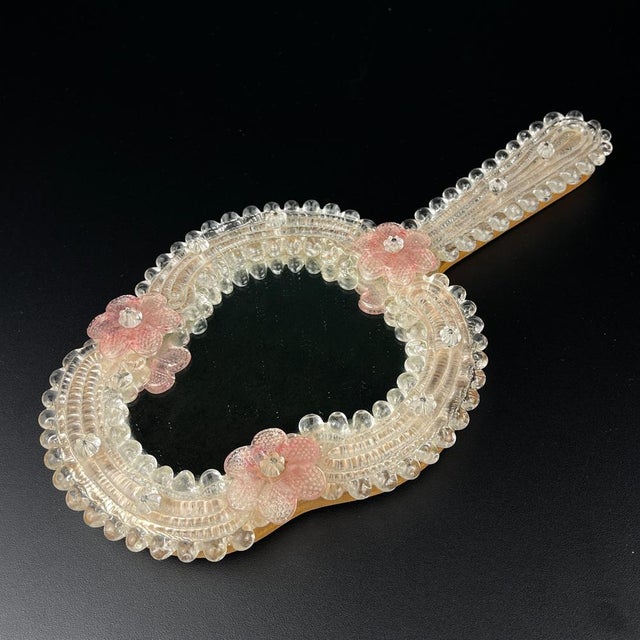 Charming Murano glass mirror made in Venice (Italy) in the 1950s. The mirror can be used as a hand mirror or wall mirror....