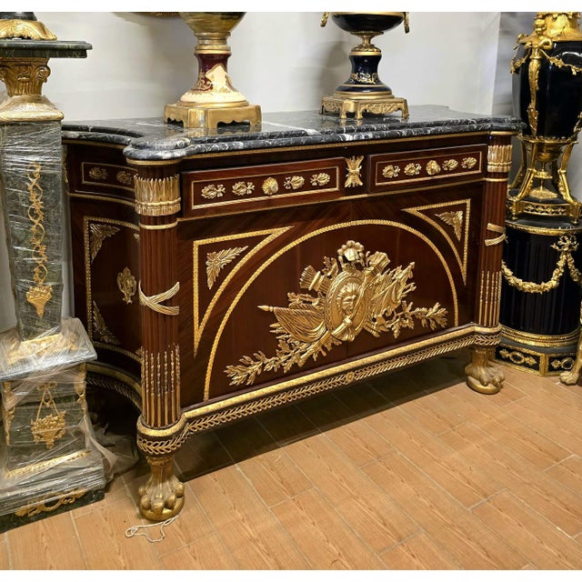 An extraordinary Louis XV style sideboard cabinet showcasing exceptional craftsmanship and lavish ornamentation...