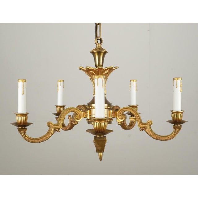 Louis XIV style chandelier made of gilded brass with five arms. The chain is made of steel. This light requires five E-12...