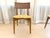 Mid-Century Modern cane-back dining chair, likely from the 1950s or 1960s. These feature a gently curved caned back, a...