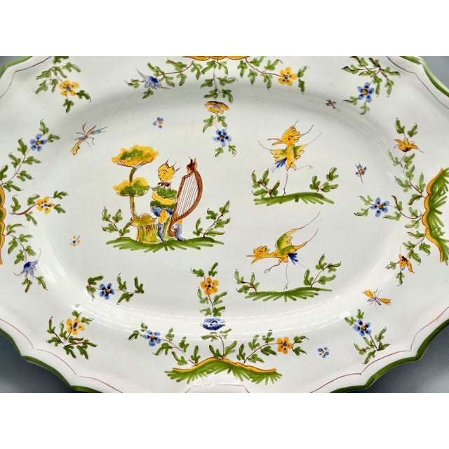 Large early 20th-Century French Moustiers faience handcrafted platter. This serving platter has a pretty scalloped edge...