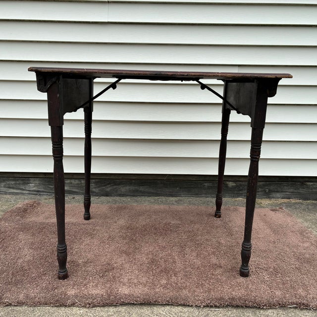 This is an antique turn of the century American wooden folding sewing or quilting table. This table is constructed with...