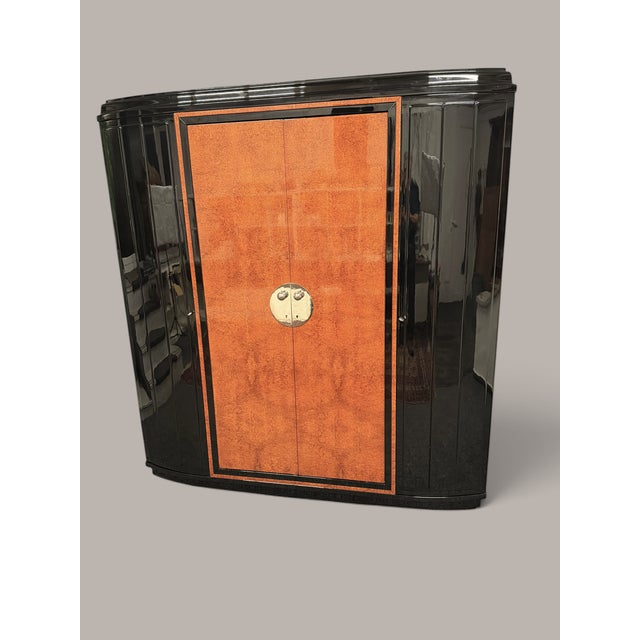 Elegant Art Deco cabinet, likely from France or Belgium, circa 1930. The tall, compact body combines dark frame elements...