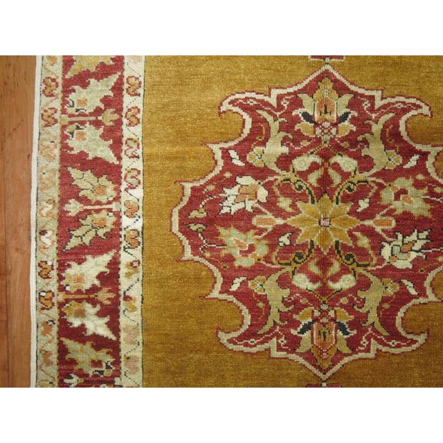Exquisite Turkish Melas rug with a mustard colored ground, deep red border and central medallion. 3'3'' x 5'6''