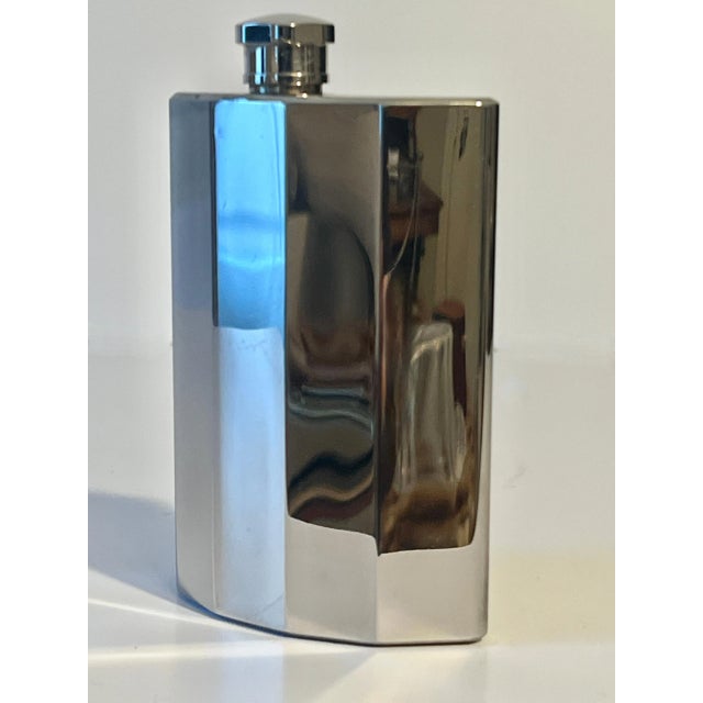 A stylish and sleek Stainless Steel polished flask. A unique curvature to the shape with ribbed edges makes this piece,...