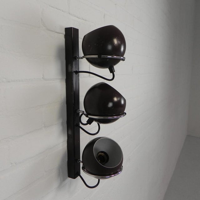This lamp is easy to hang on a screw in the wall: there is a hook with a hole on the back of the vertical u-profile....