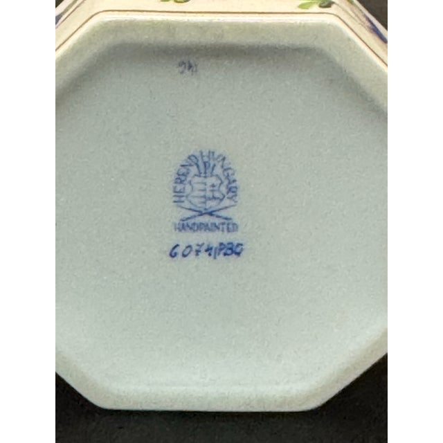 The Herend Hungary Blue Garland PBG Hand Painted Octagon Box Kitty Cat Finial 6074 is a charming trinket box originating...