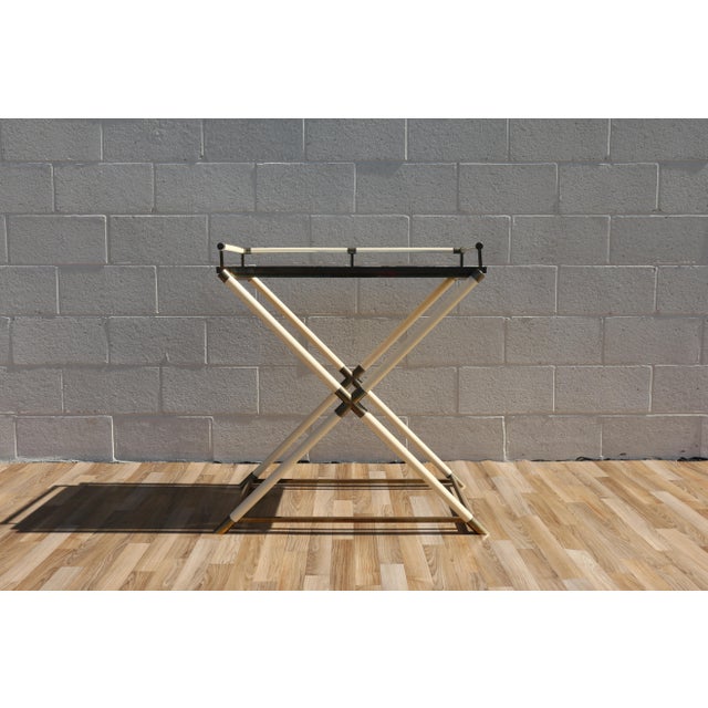 Elegant 1970s bar tray table featuring a striking faux ivory lacquer frame with warm brass accents and a removable...