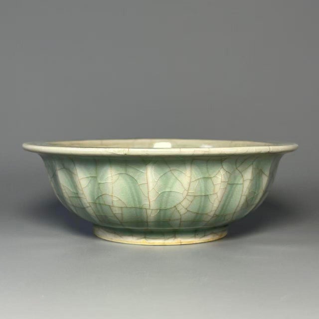 This lobed‑form bowl is made of authentic Longquan Celadon. It features classic celadon‑green glaze with natural...