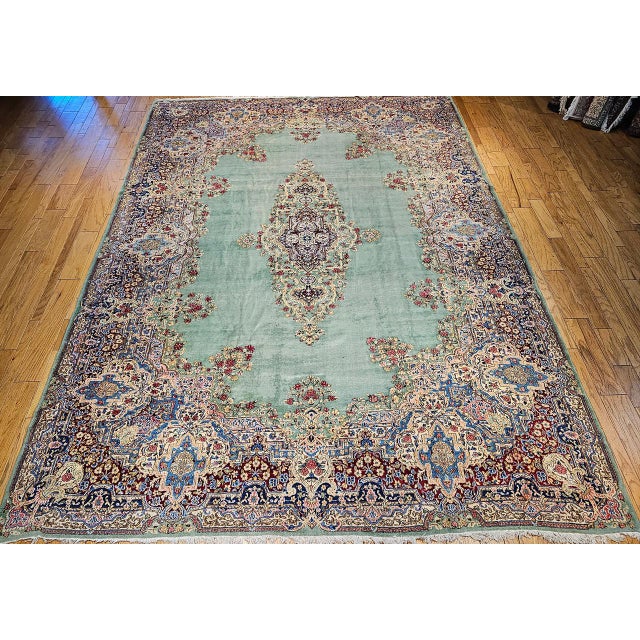 "An elegant vintage oversized Persian Kerman carpet woven circa the 1940s in a rare and breathtaking pale green — a color...