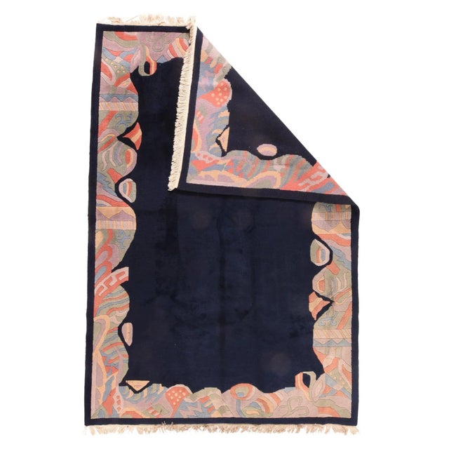 The deep navy open field is erratically edged with a surging and fracturing border highlighted with bits of ribbon,...