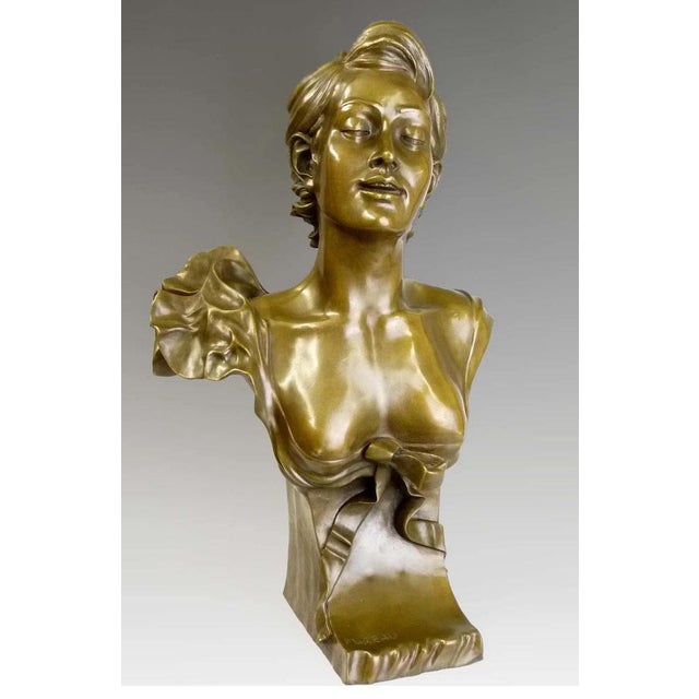 Art Nouveau gold patinated bronze bust sculpture from the 20th century. This bronze bust represents a young woman with...