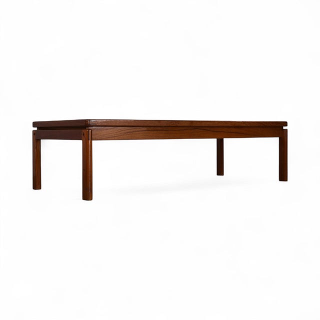 This Danish modern coffee table features a clean, rectilinear teak frame fitted with three inset panels of smoked glass....