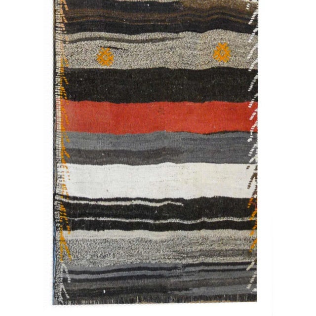 A fantastic mid-20th century Turkish Konya Kilim runner with alternating crimson, orange, black, white, and gray stripes...