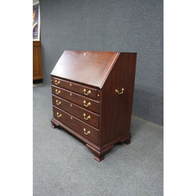 Classic Henkel Harris mahogany secretary desk in the Chippendale tradition, featuring a 30-inch writing surface and an...