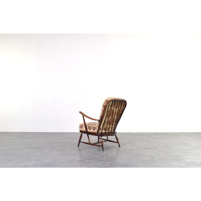 A pair of armchairs designed by Lucian Ercolani and produced by the renowned British manufacturer Ercol during the 1960s....