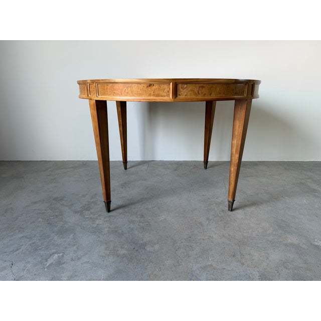 Beautiful vintage Mid Century Modern expandable dining table featuring a stunning bookmatched veneer top with a burl wood...