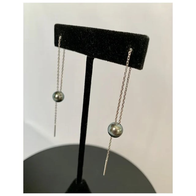 Unique 8mm Tahitian black pearl and 14k white gold earrings purchased in Bora Bora. The pearl is suspended from a delicate...