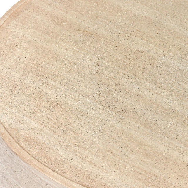 Outdoor coffee table cast in lightweight concrete with a soft faux travertine finish, offering the look of natural stone...