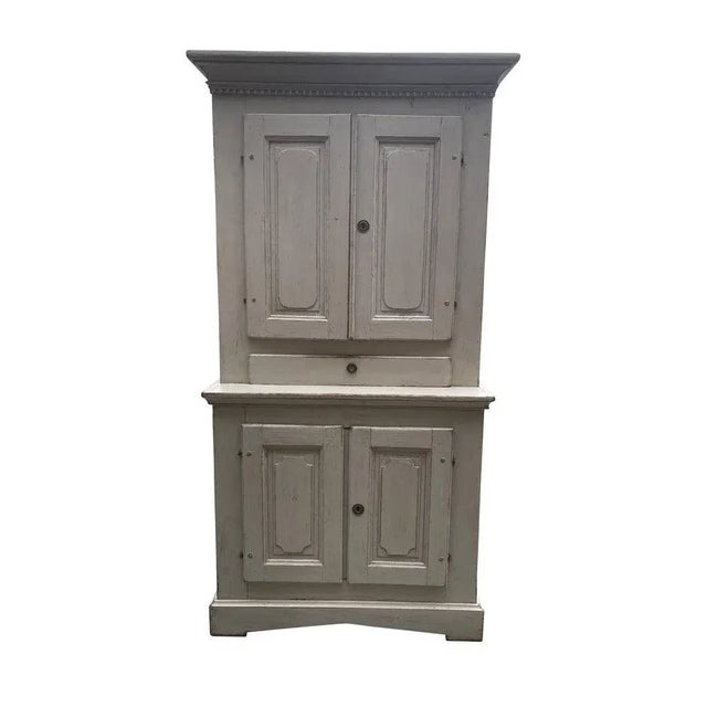 Perfect and already set up a media cabinet, this Swedish Gustavian cupboard in a lime-washed finish, 19th century, has two...