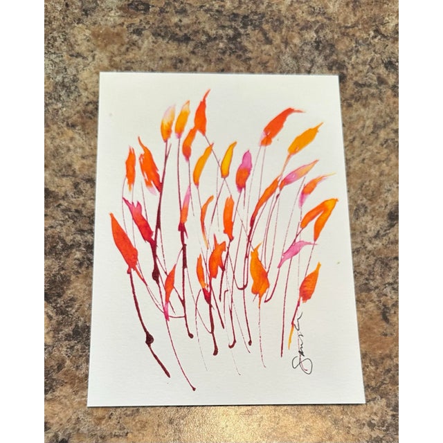 Brilliant orange and scarlet leaves sweep upward, like fire dancing in the breeze, full of warmth and vitality.