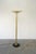 A classic uplight Torchere floor lamp with three vertical brass rods supporting a shallow brass bowl and wider glass...