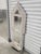 Vintage painted reclaim wood arched mirror with bottom shelf. The mirror was originally a window, panels and shelf were...