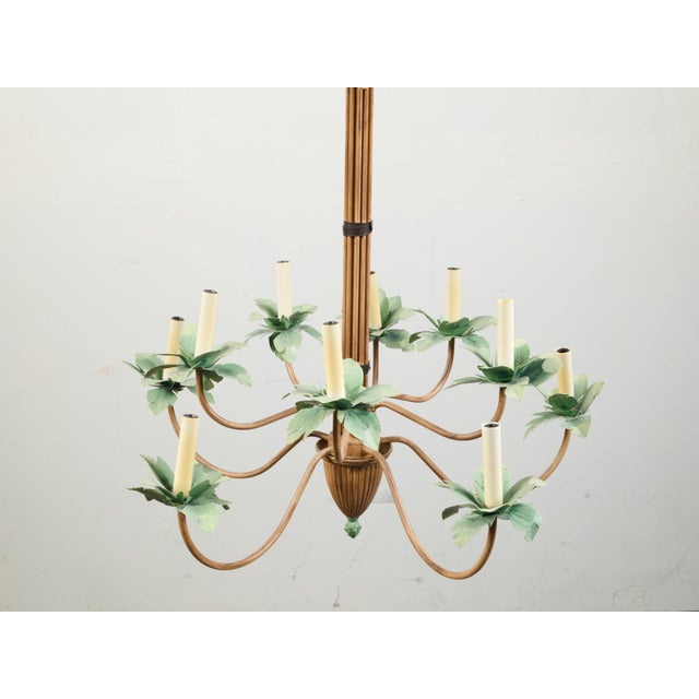 A vintage painted tôle palm tree light fixture from the mid 20th century, with 10 lights and swoop arms. Created during...